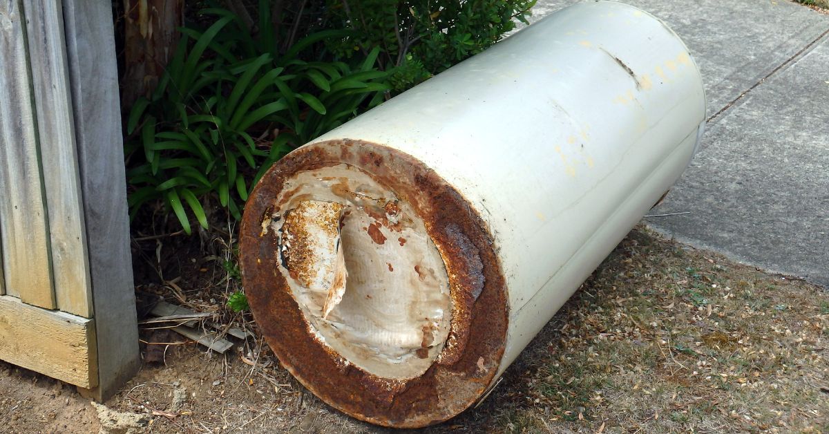 hot water system boiler old dumped in the street